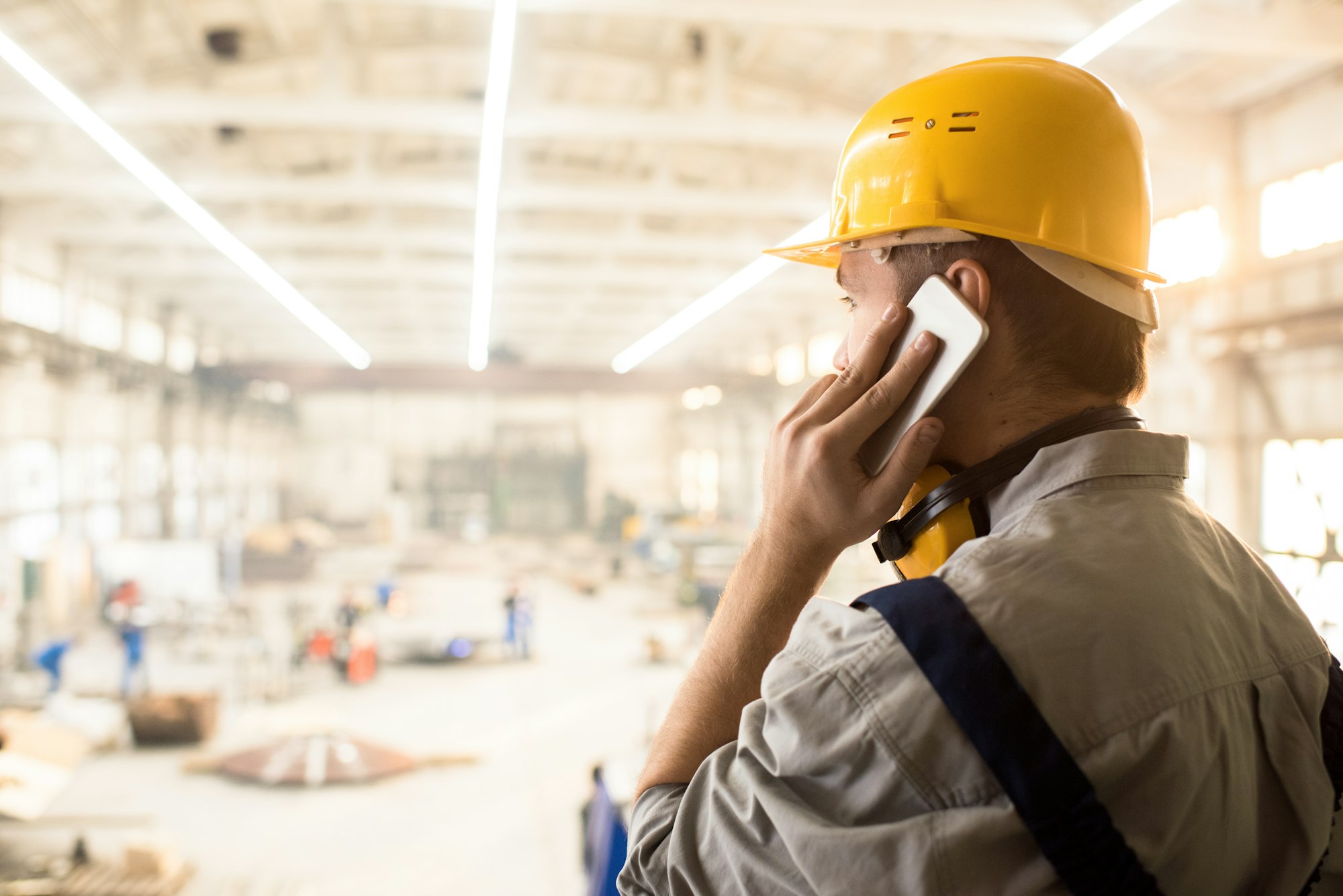 Busy construction manager calling customer